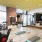 exercise equipment in a room with hardwood floors and large mirros